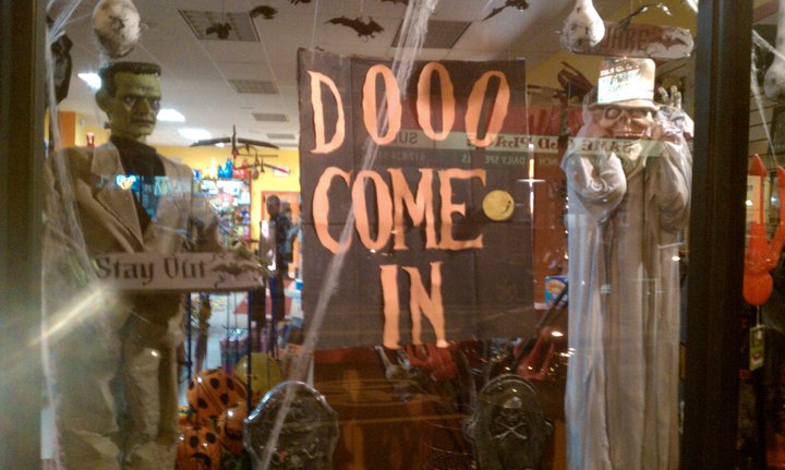 Halloween window display from years past at Boing! Features a couple of spooky signs, a ghost, a frankenstein, spiderwebs, and other little details
